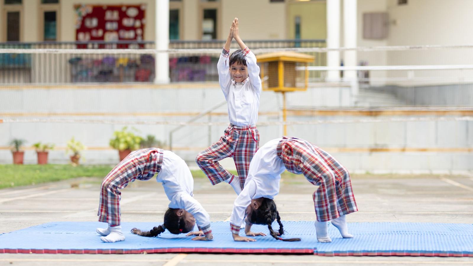 Children Practicing Yoga Outdoors at School